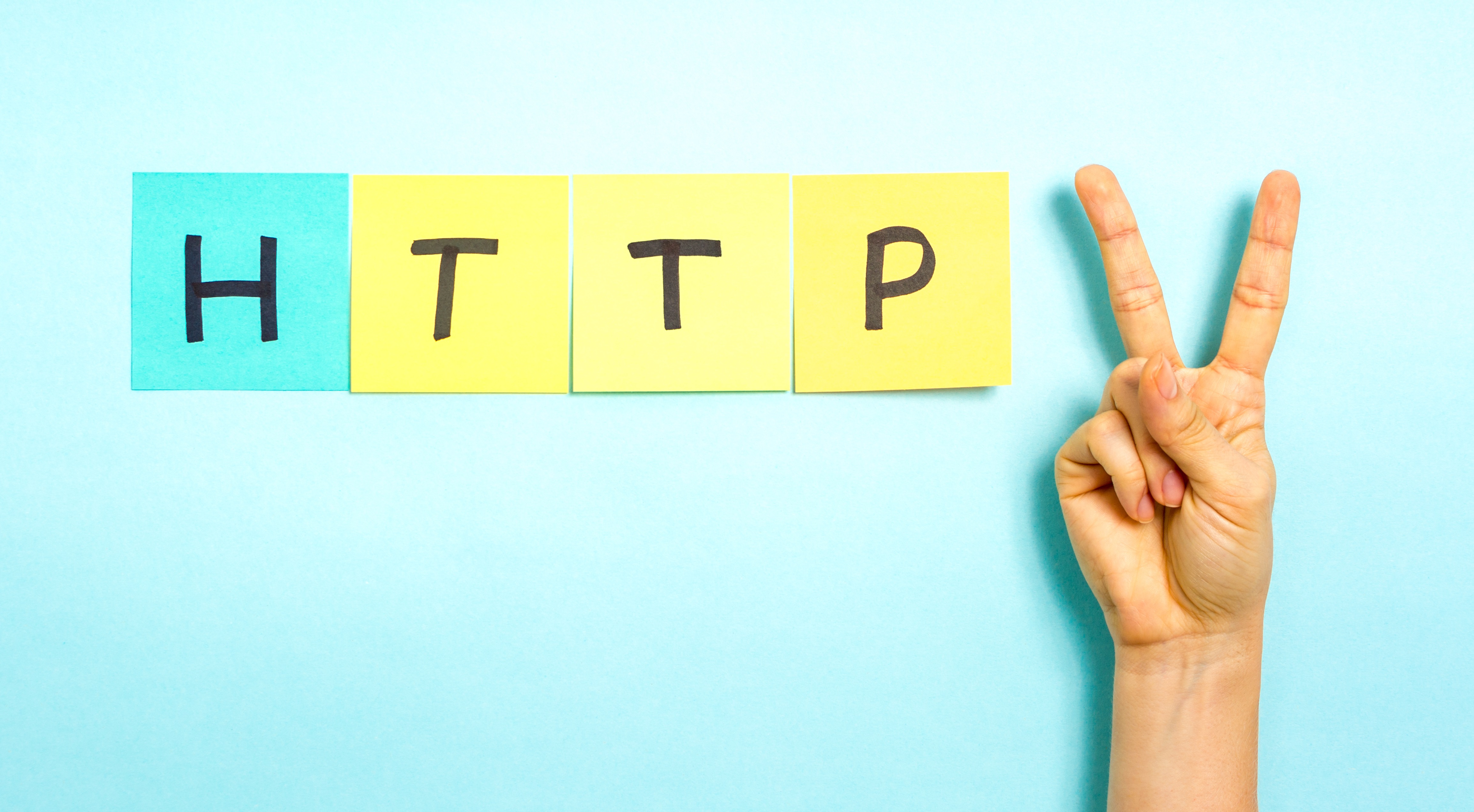 HTTP 2. Hand making V sign gesture, success symbol, on blue background.